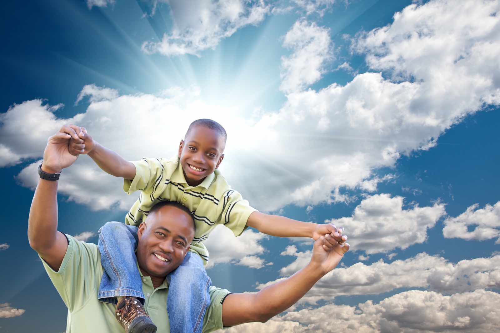 Father and son embracing the sunshine